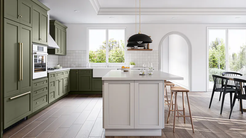 Kitchen with deep green shaker cabinets along the wall and a white island with wood stools