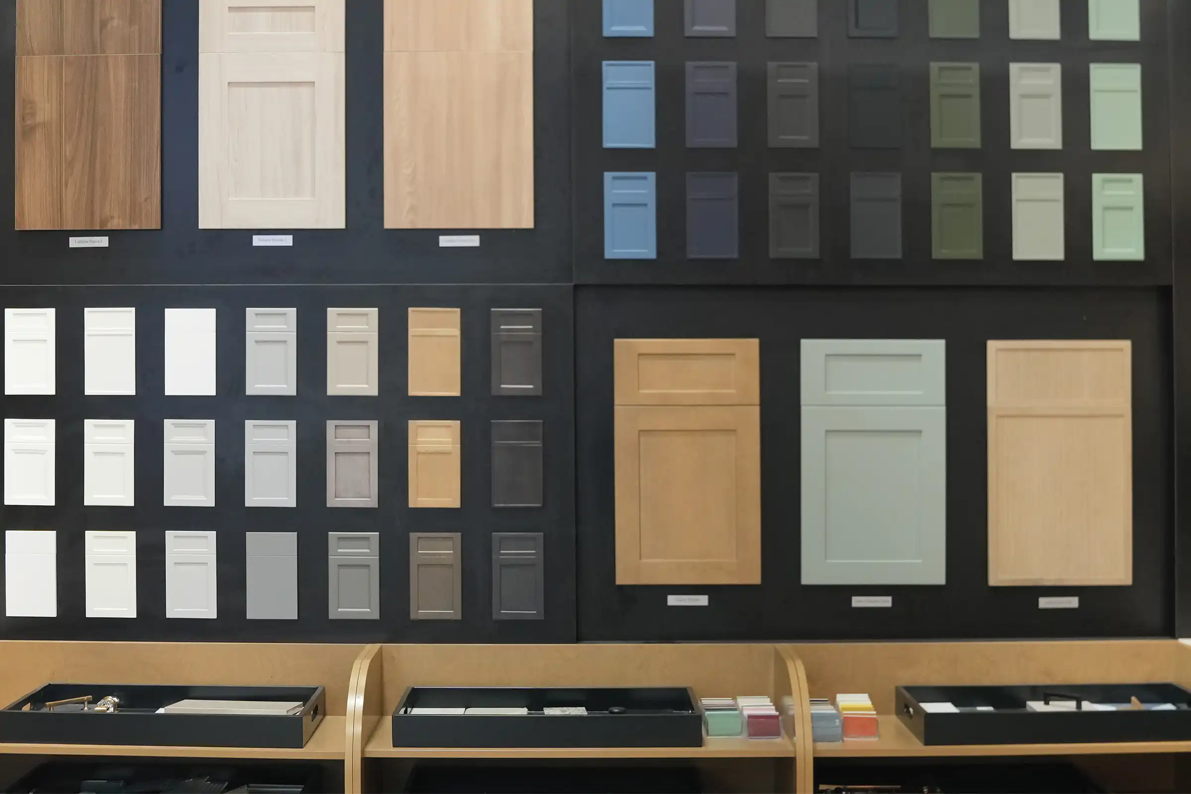 A display wall of cabinet door samples in wood, white, gray, blue and green